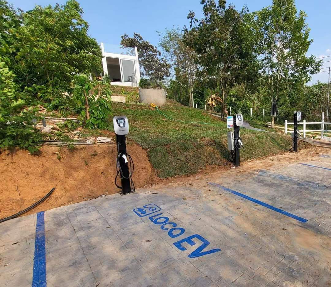 Rural American setting featuring an AC EV Charger by Pilot x Piwin, highlighting eco-friendly charging solutions in picturesque countryside locations.